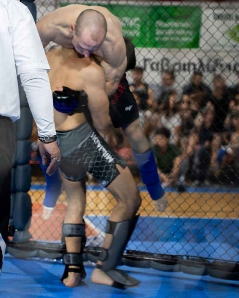 Miliadis Nikos in a clinch with the referee in front